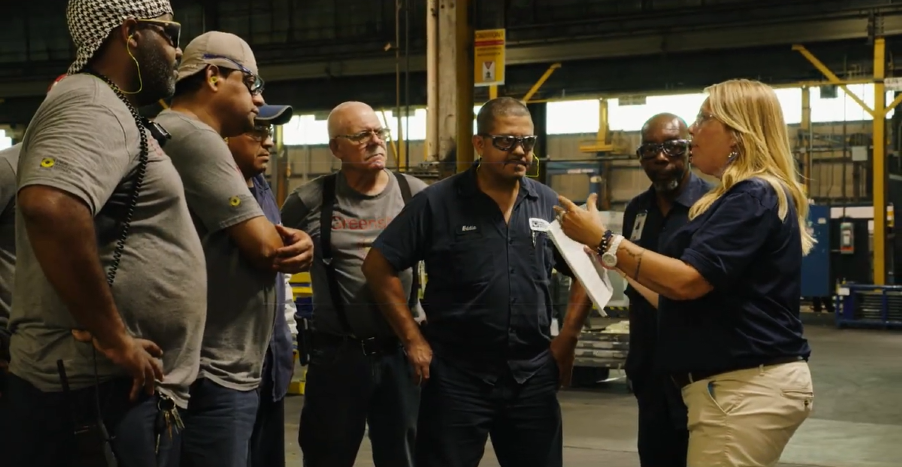 team consulting in manufacturing plant